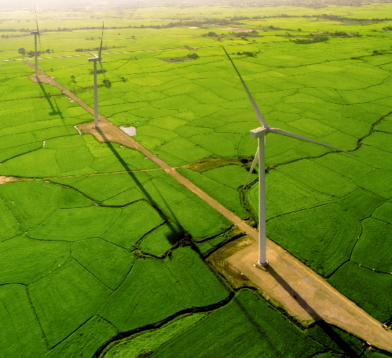  Windmills generate clean, renewable energy in a rural area, contributing to a more sustainable environment and reducing reliance on fossil fuels