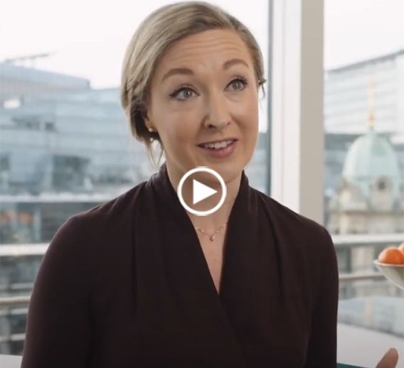  Rebekah Clement during her interview and a play button, indicating a video case study